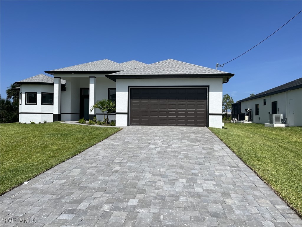 a front view of a house with a yard and garage