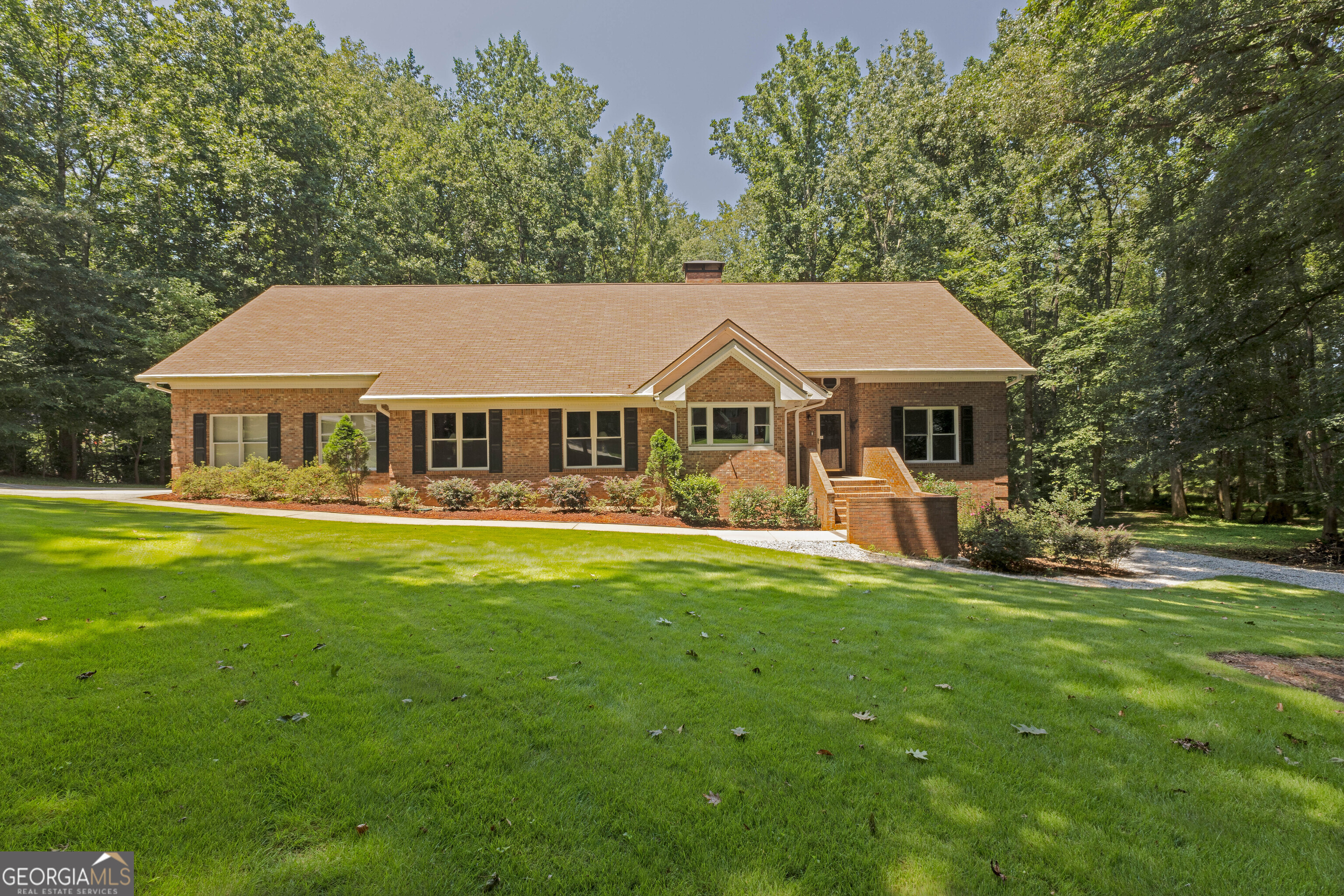 a front view of a house with a garden