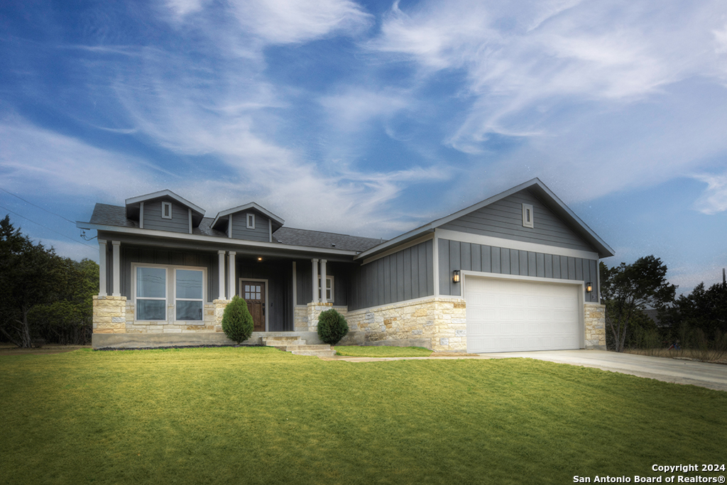 a front view of house with yard and green space