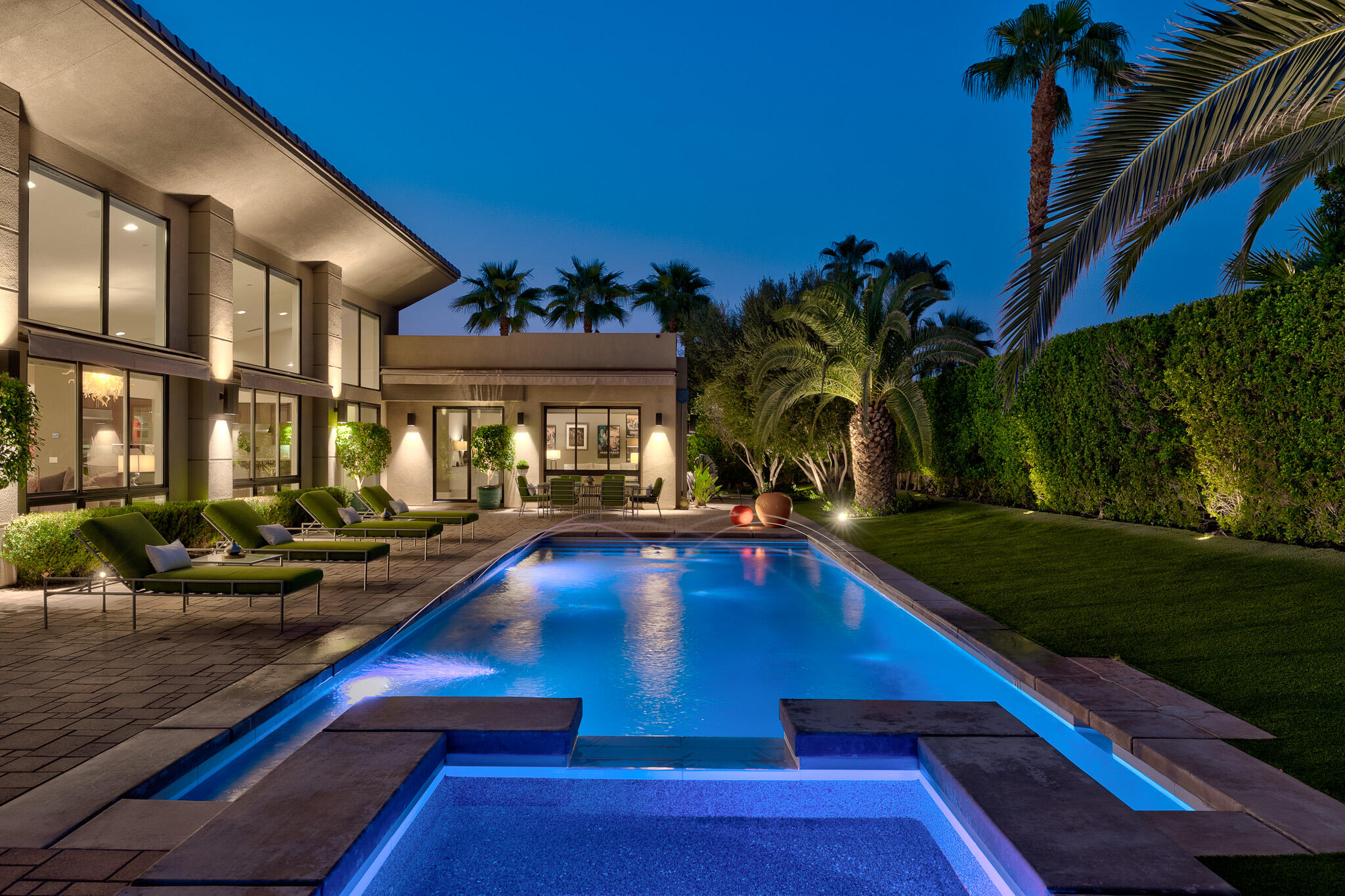 a view of swimming pool with outdoor seating and a potted plant