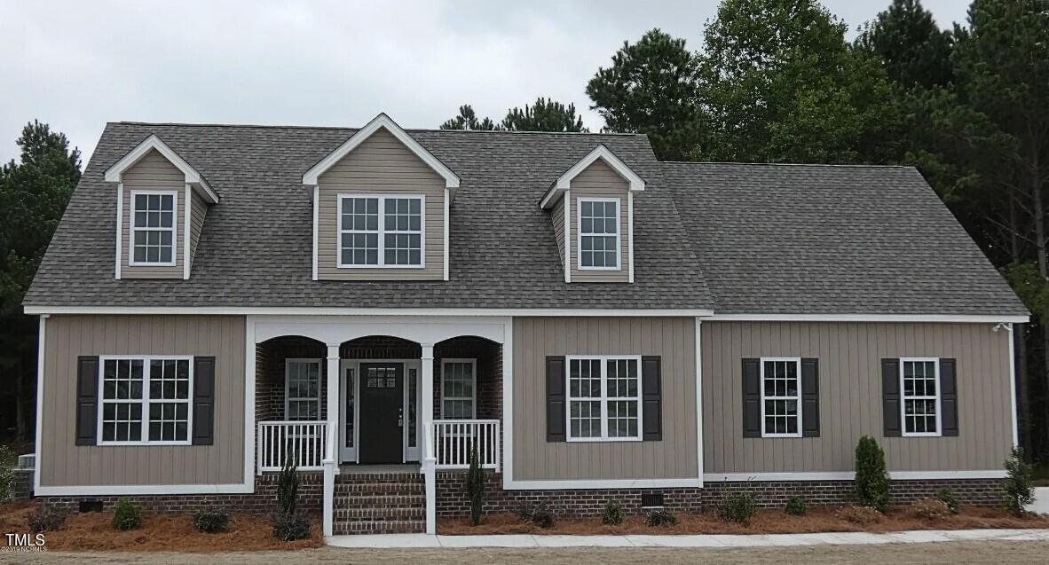 a view of a brick house with large windows