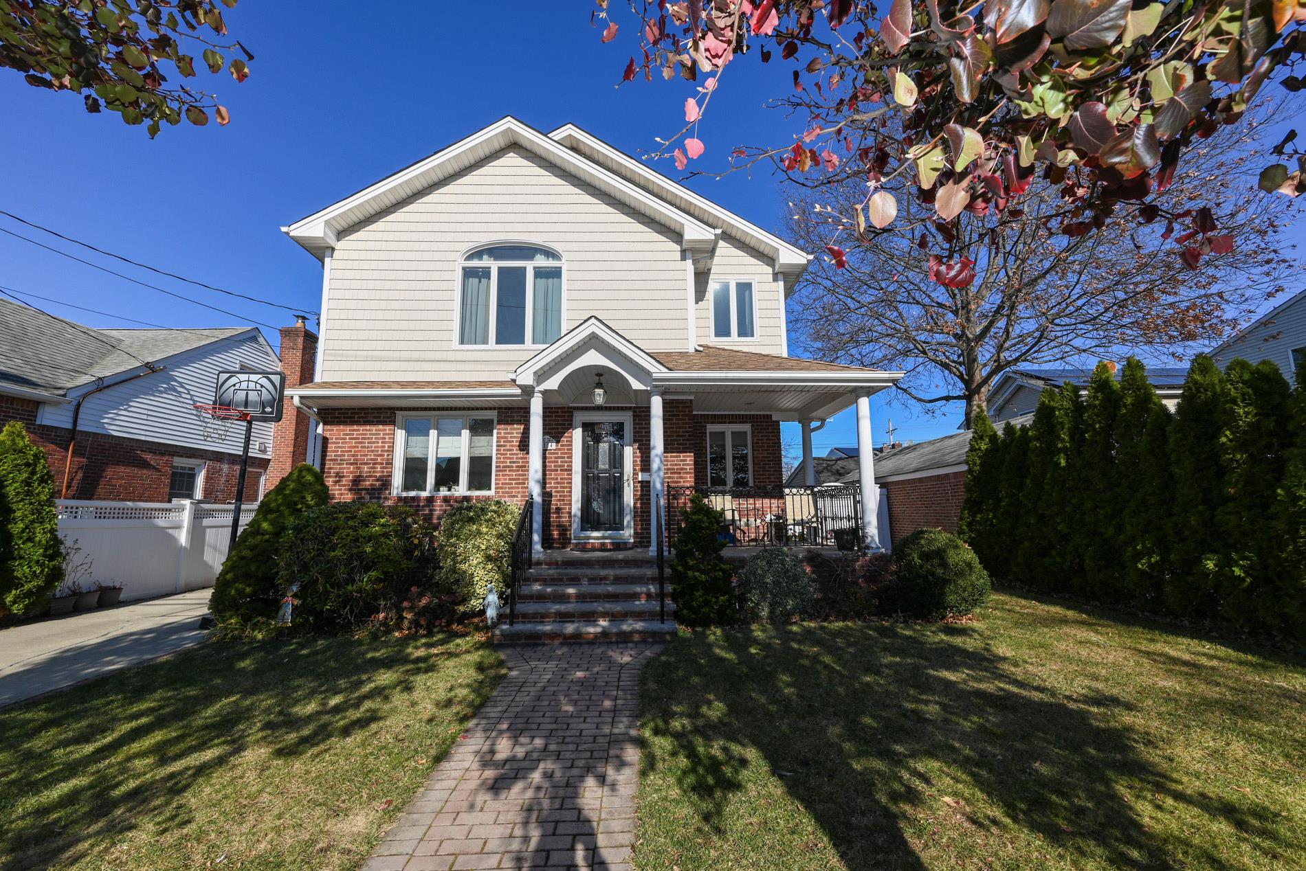 View of front of property with a porch and a front yard