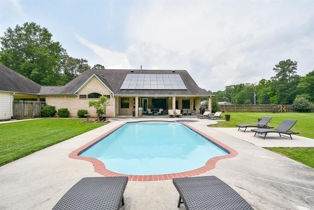 a view of a house with swimming pool and yard