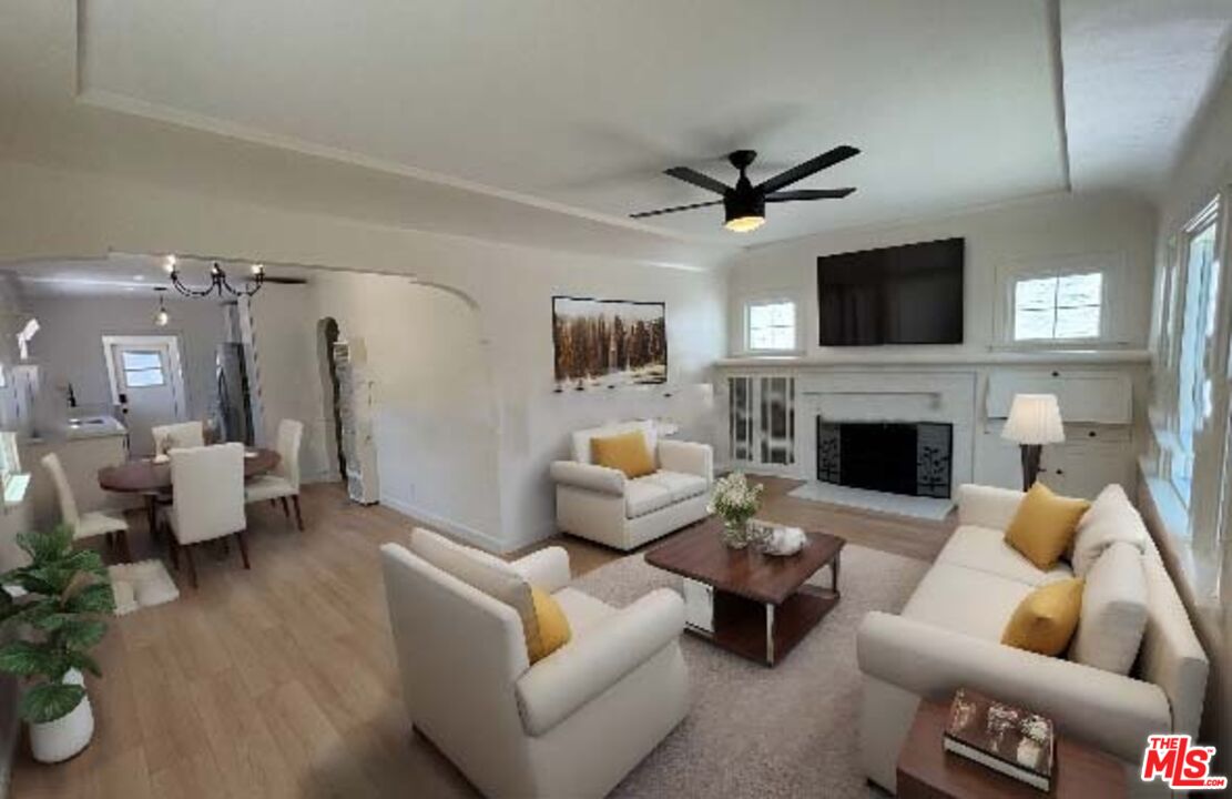 a living room with furniture a fireplace and a flat screen tv