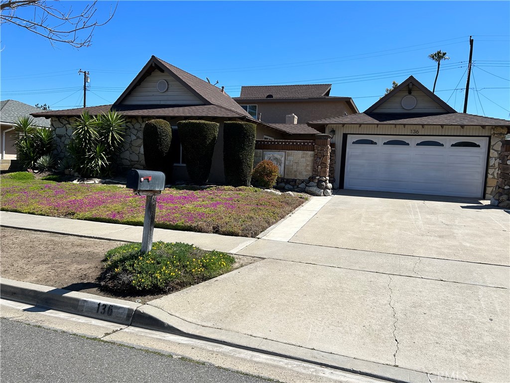 a front view of a house with garden