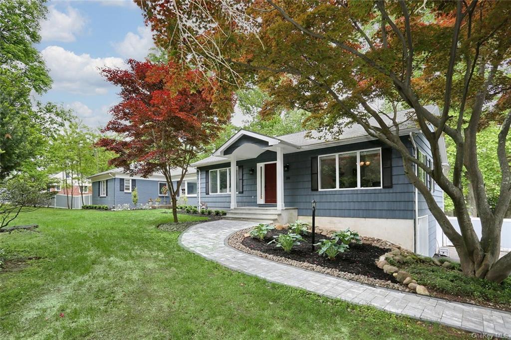 a front view of a house with a garden