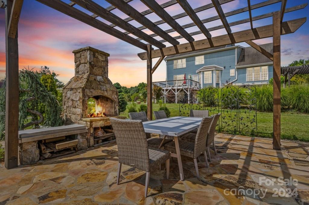 a view of a patio with a table chairs and a yard