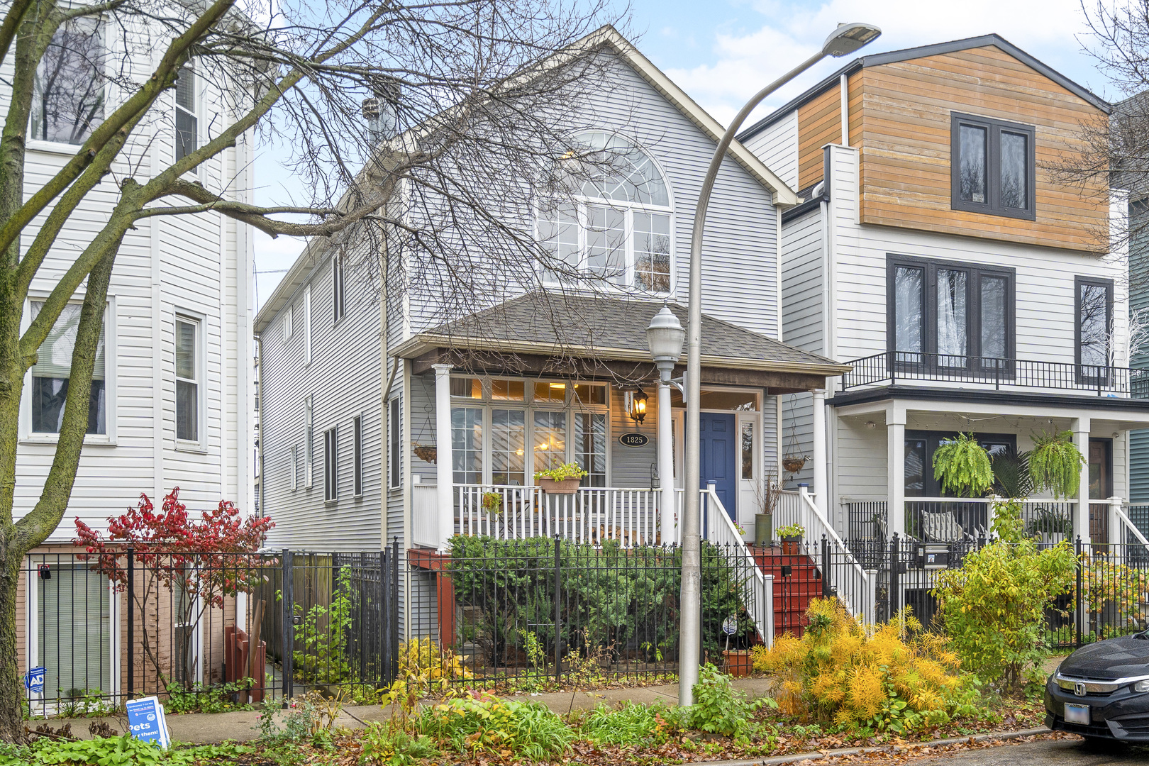 a view of a house with small yard and potted plants