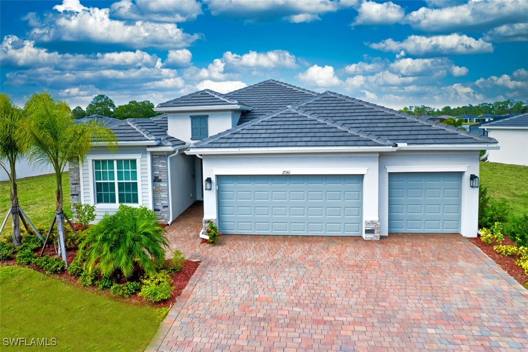 a front view of a house with a yard and garage