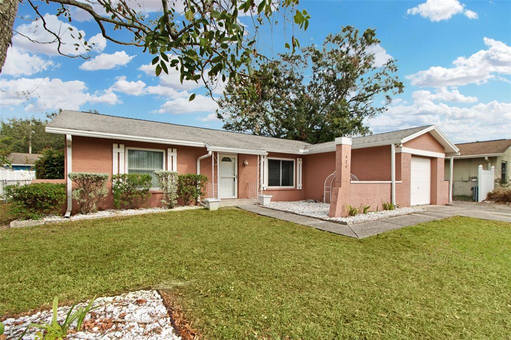 a front view of house with yard and green space