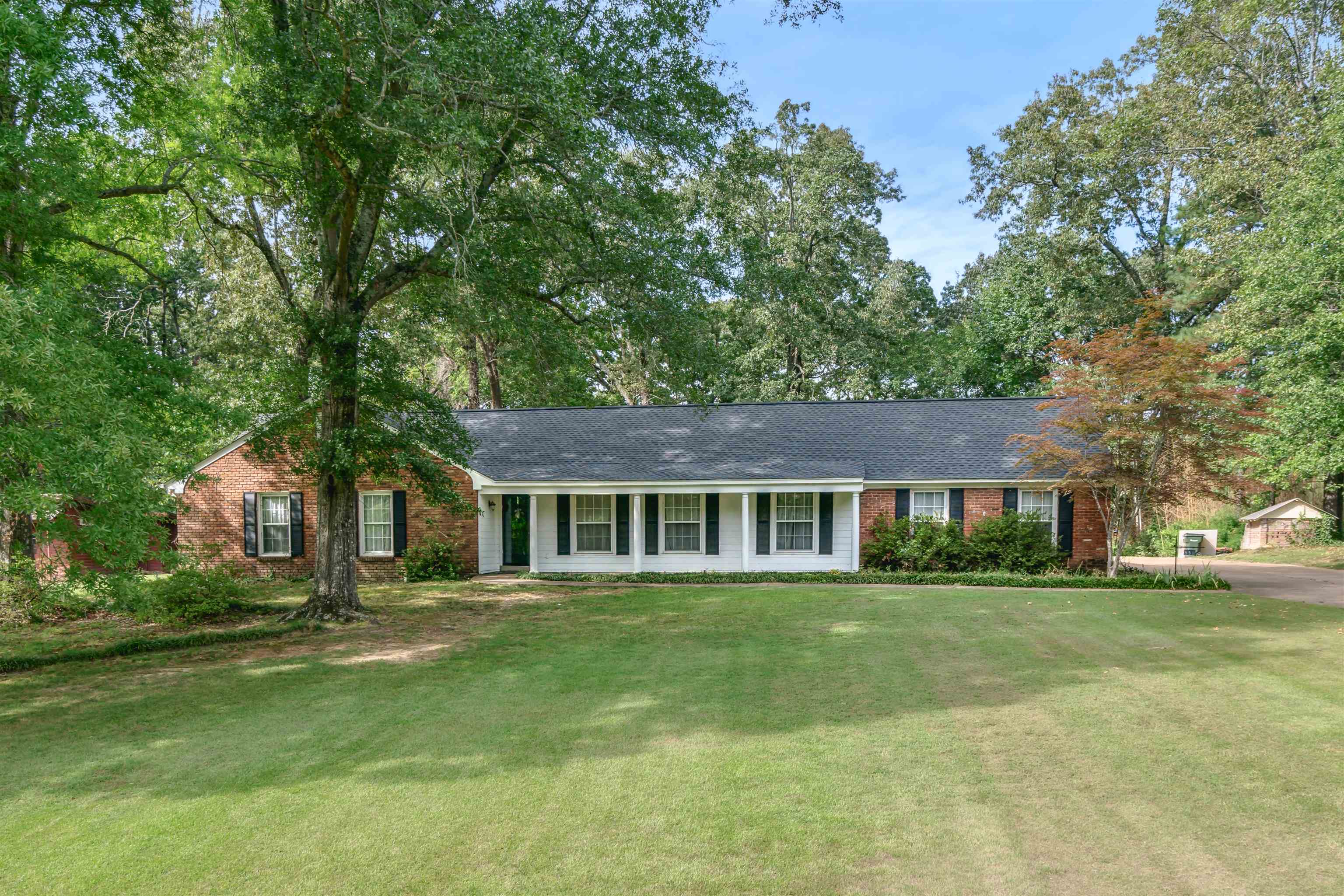 Ranch-style home featuring a front yard