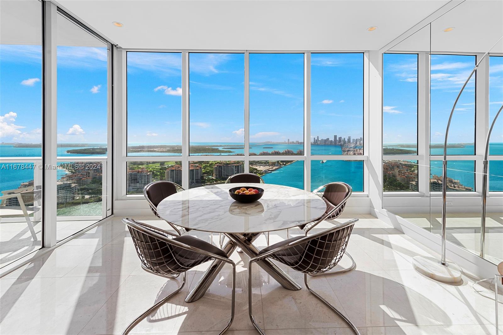 a living room with a table and chairs next to a window