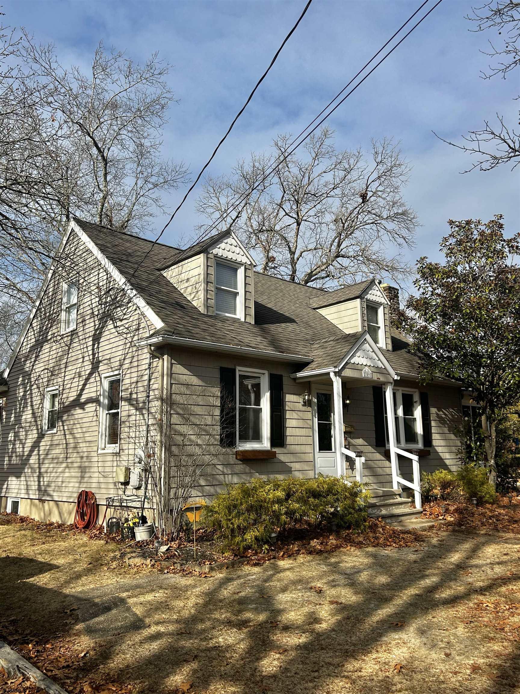 a front view of a house with a road