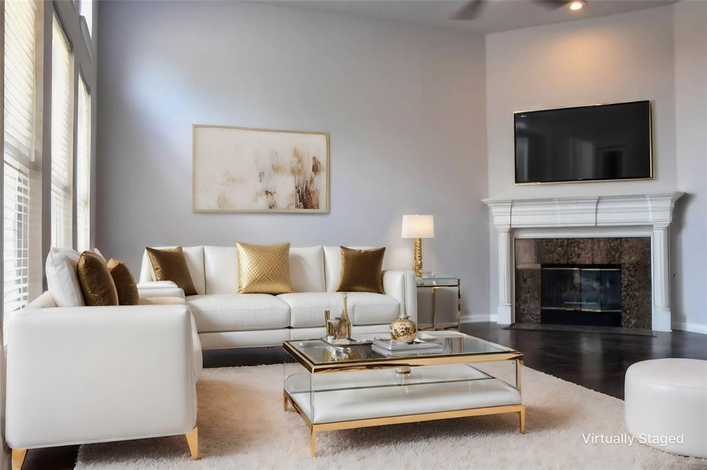 a living room with furniture a fireplace and a flat screen tv