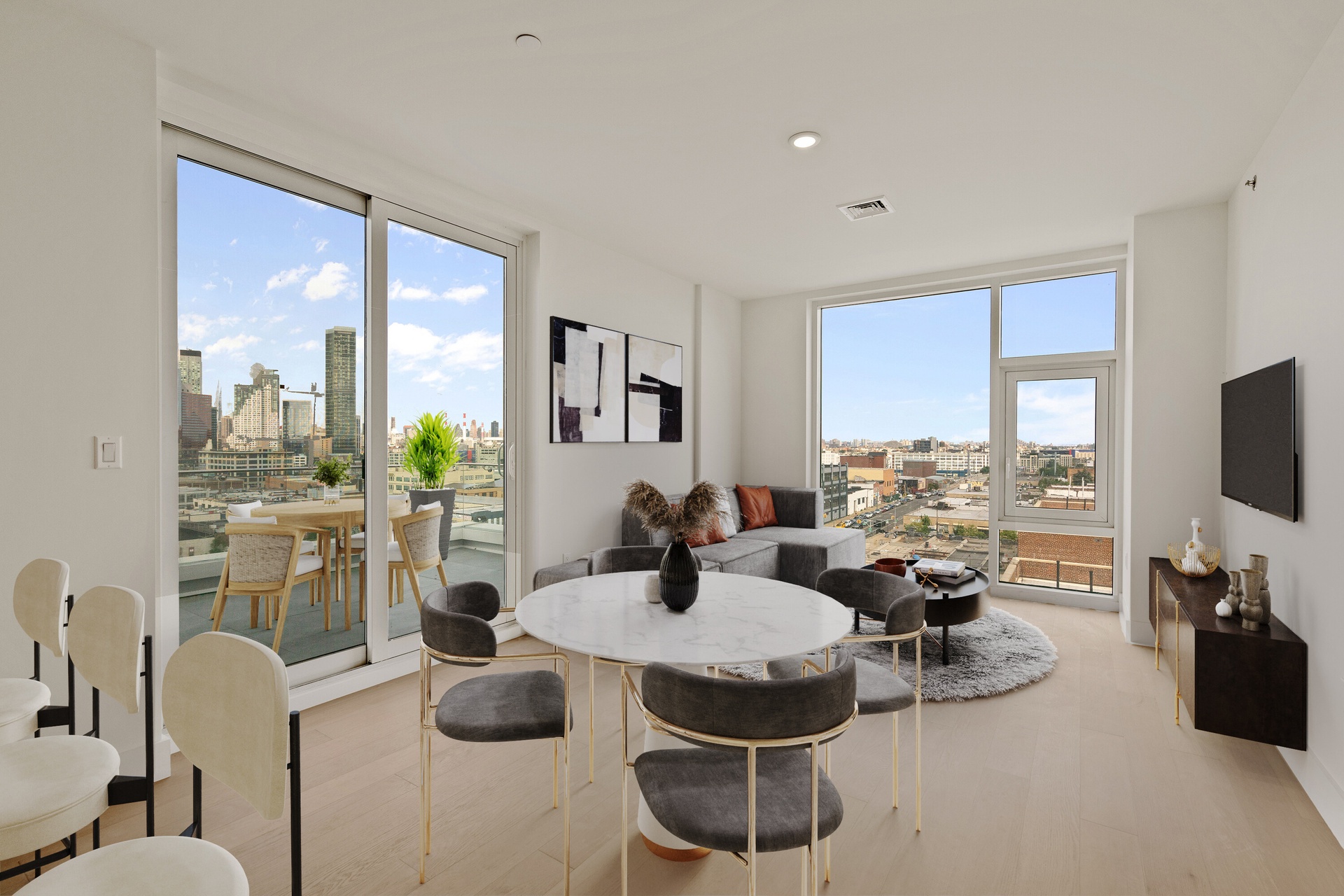 a dining room with furniture a rug a large window and plants