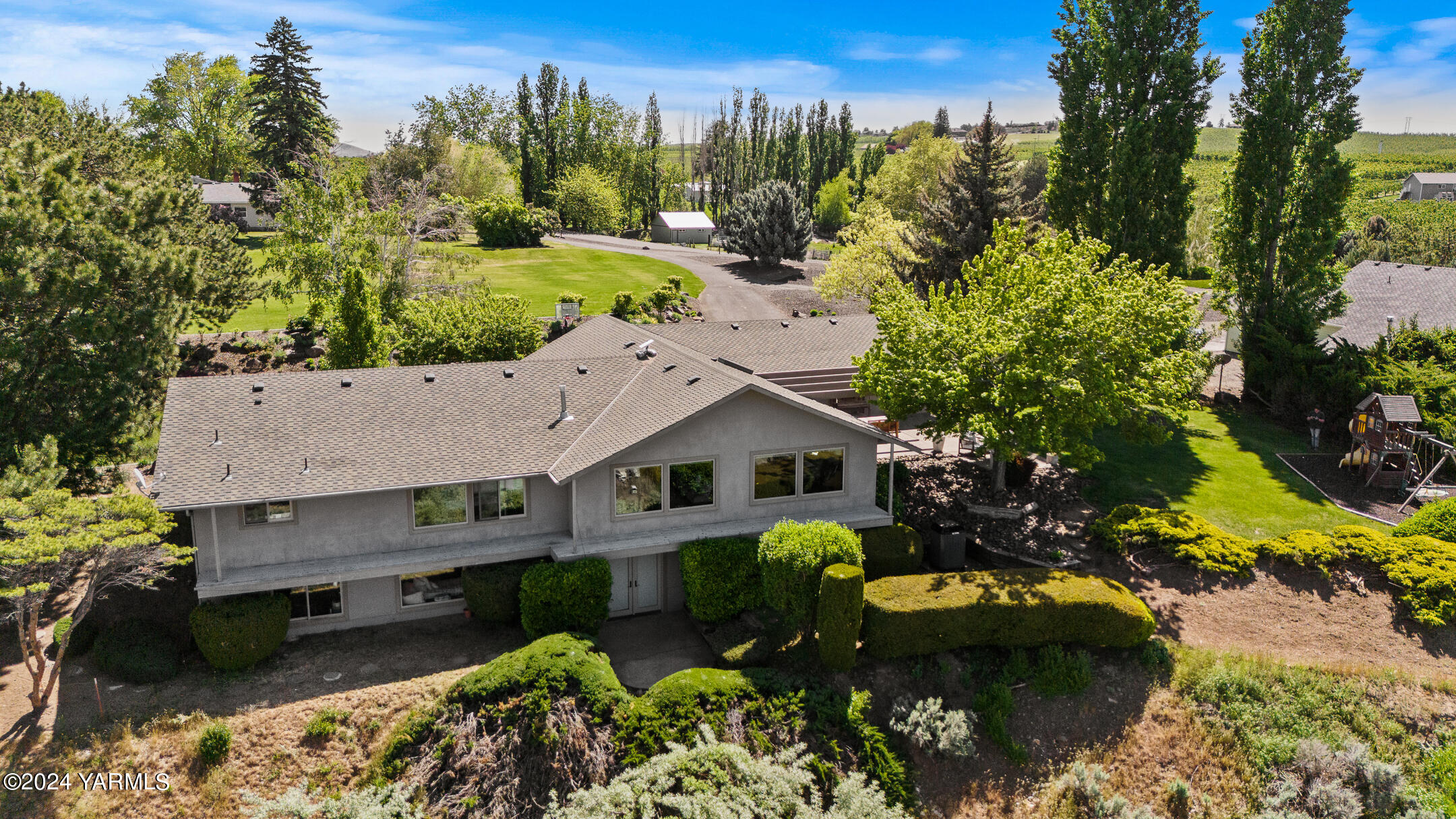 a aerial view of a house with a yard basket ball court and outdoor seating