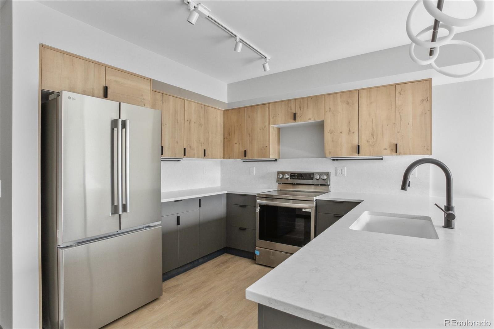 a kitchen with stainless steel appliances a refrigerator stove and sink