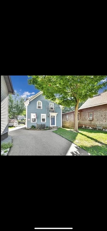 a view of house with yard