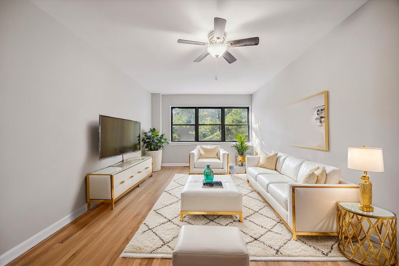 Living room with ceiling fan and light wood-type flooring