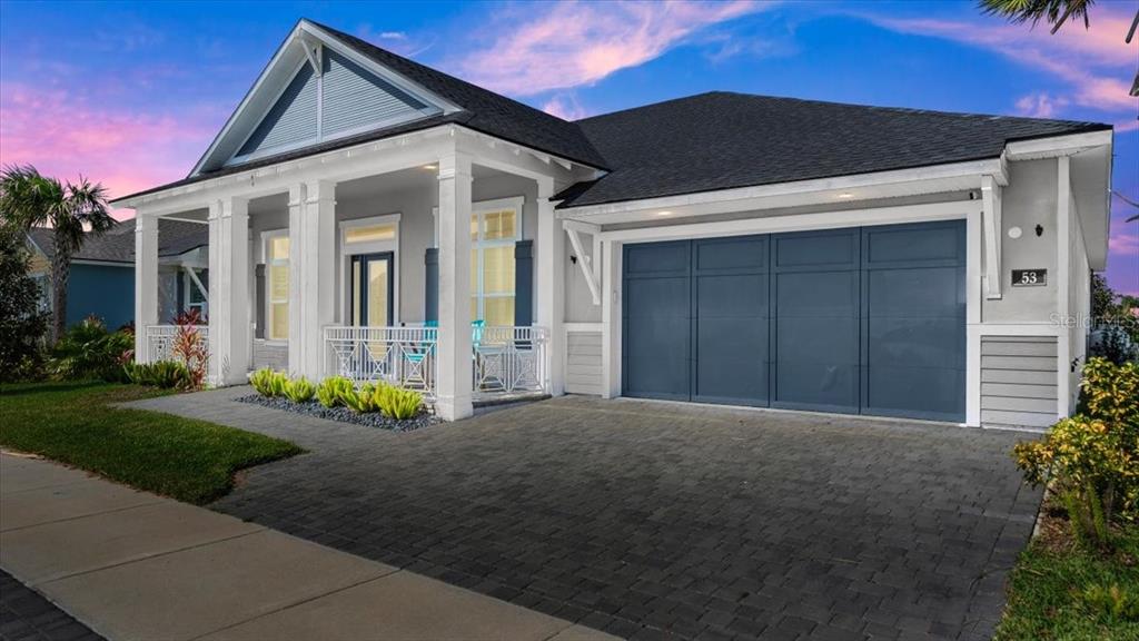 a front view of a house with a yard and outdoor seating