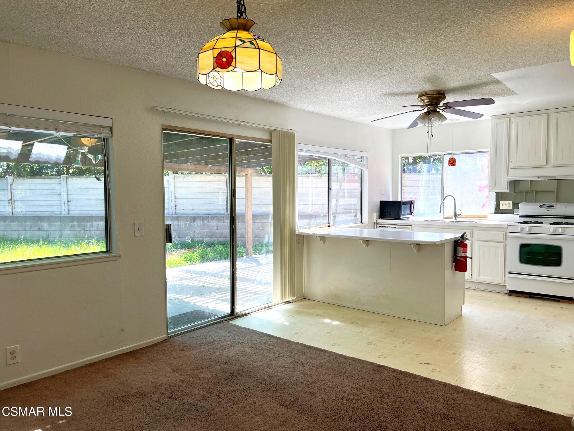 a view of a kitchen with a stove cabinets