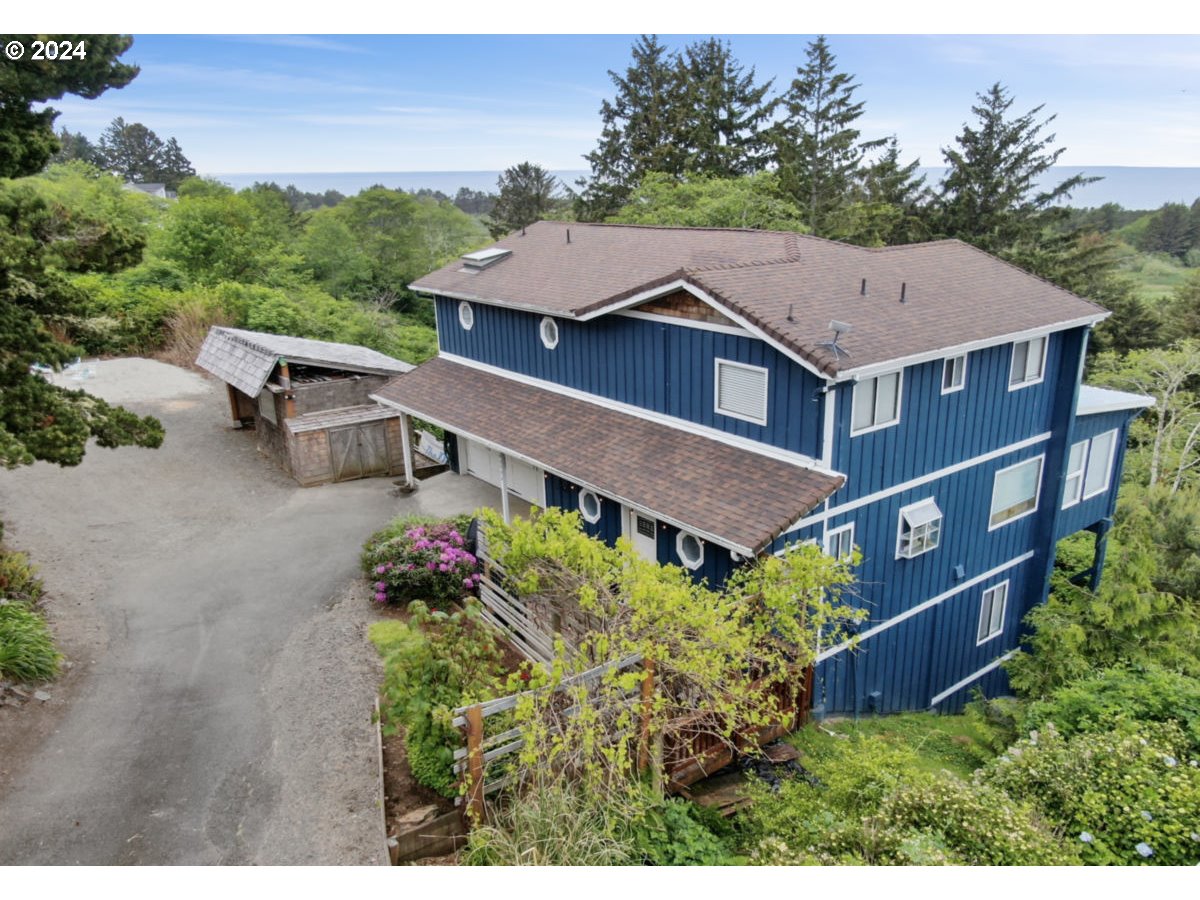 an aerial view of a house with yard and lake view