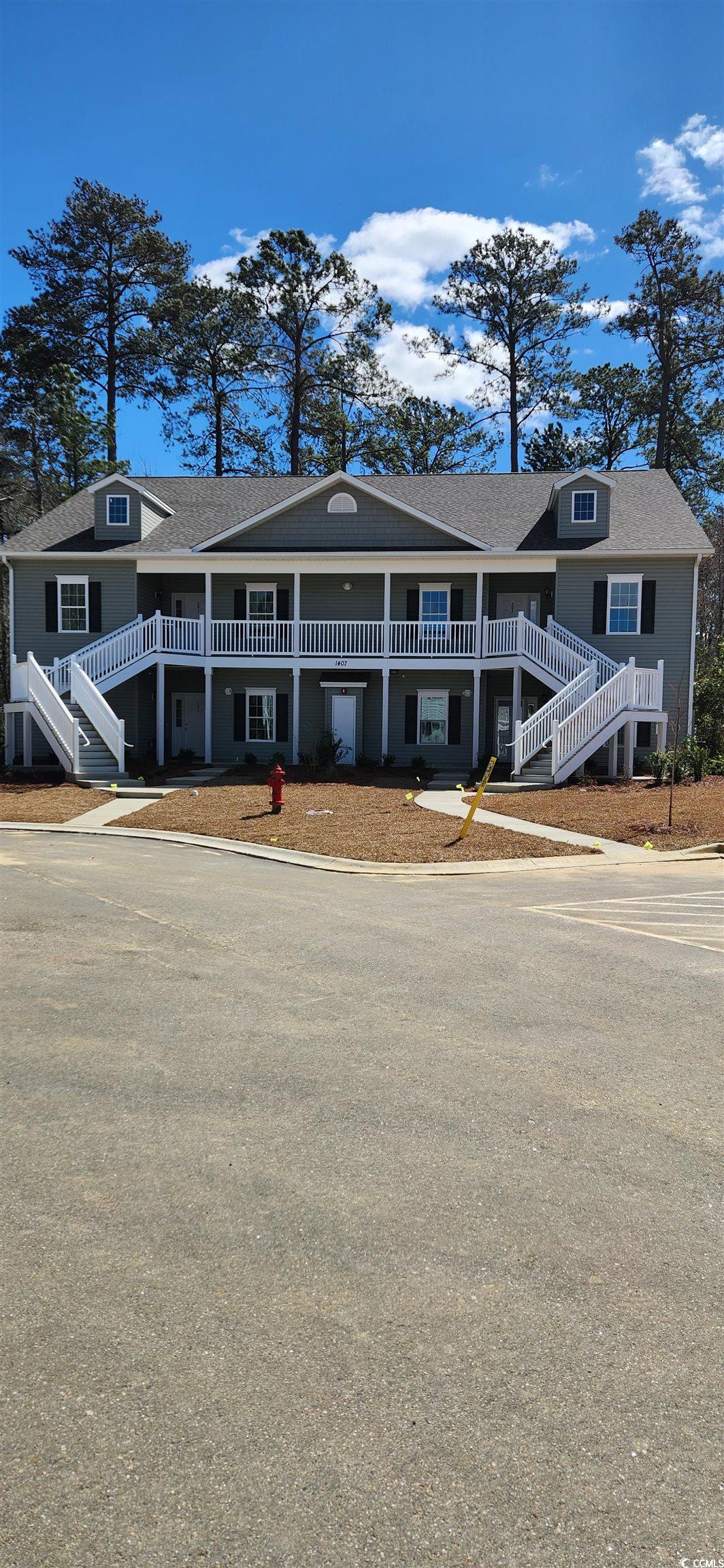 View of front facade featuring stairs