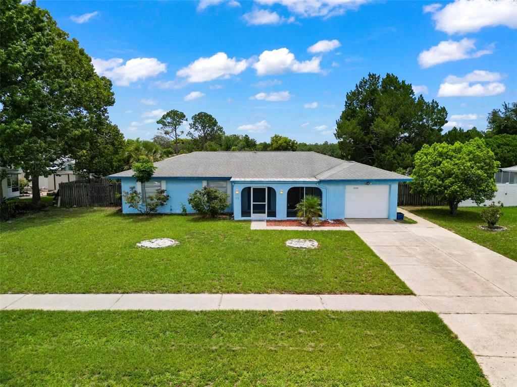 a front view of house with yard and green space