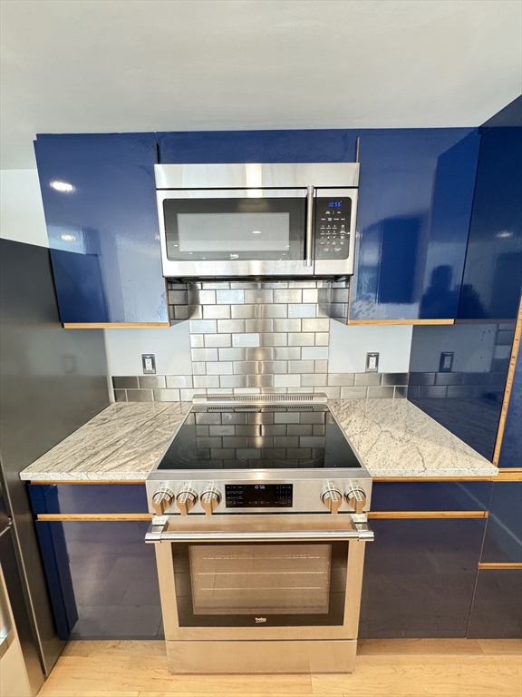 a stove top oven sitting inside of a kitchen