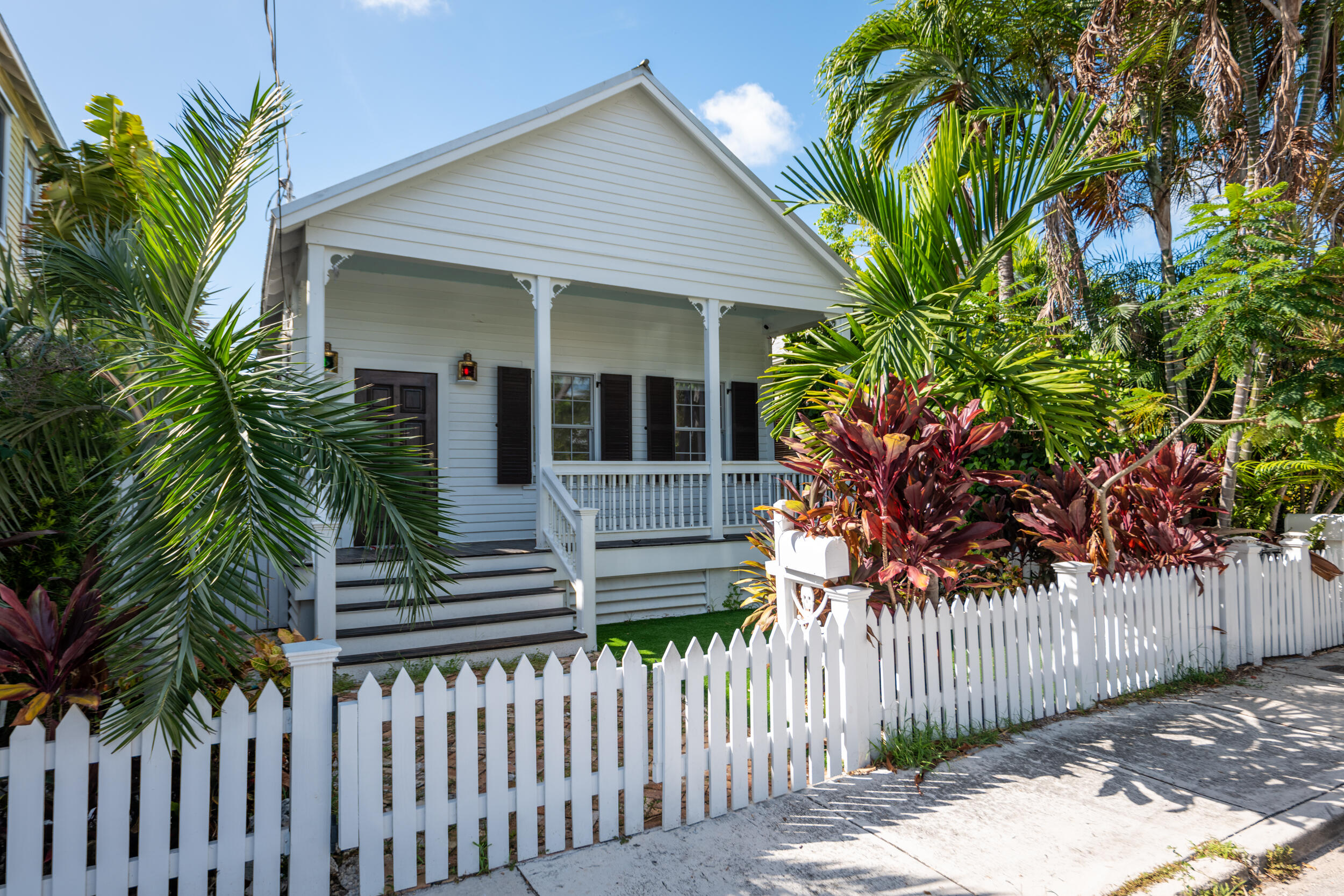 a front view of a house with a tree