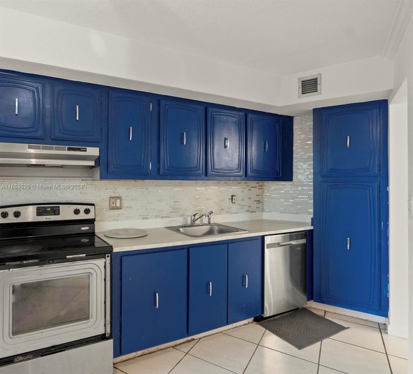 a kitchen with stainless steel appliances granite countertop wooden cabinets and sink