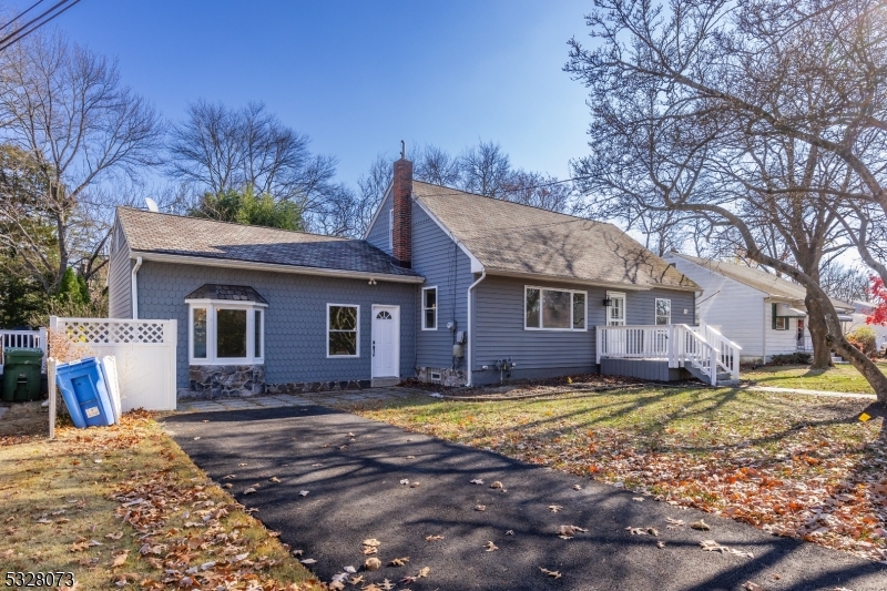 a view of a house with a yard and large tree