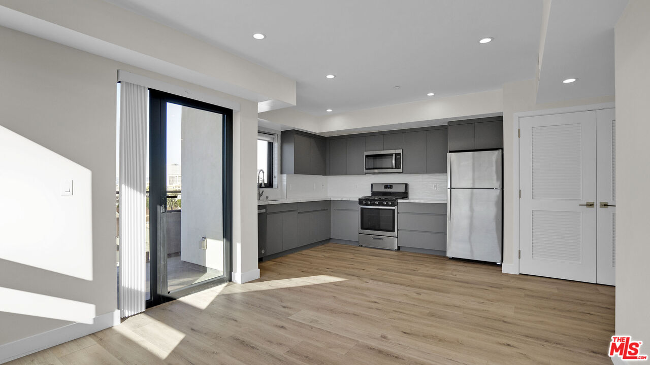 a kitchen with stainless steel appliances a refrigerator and a sink