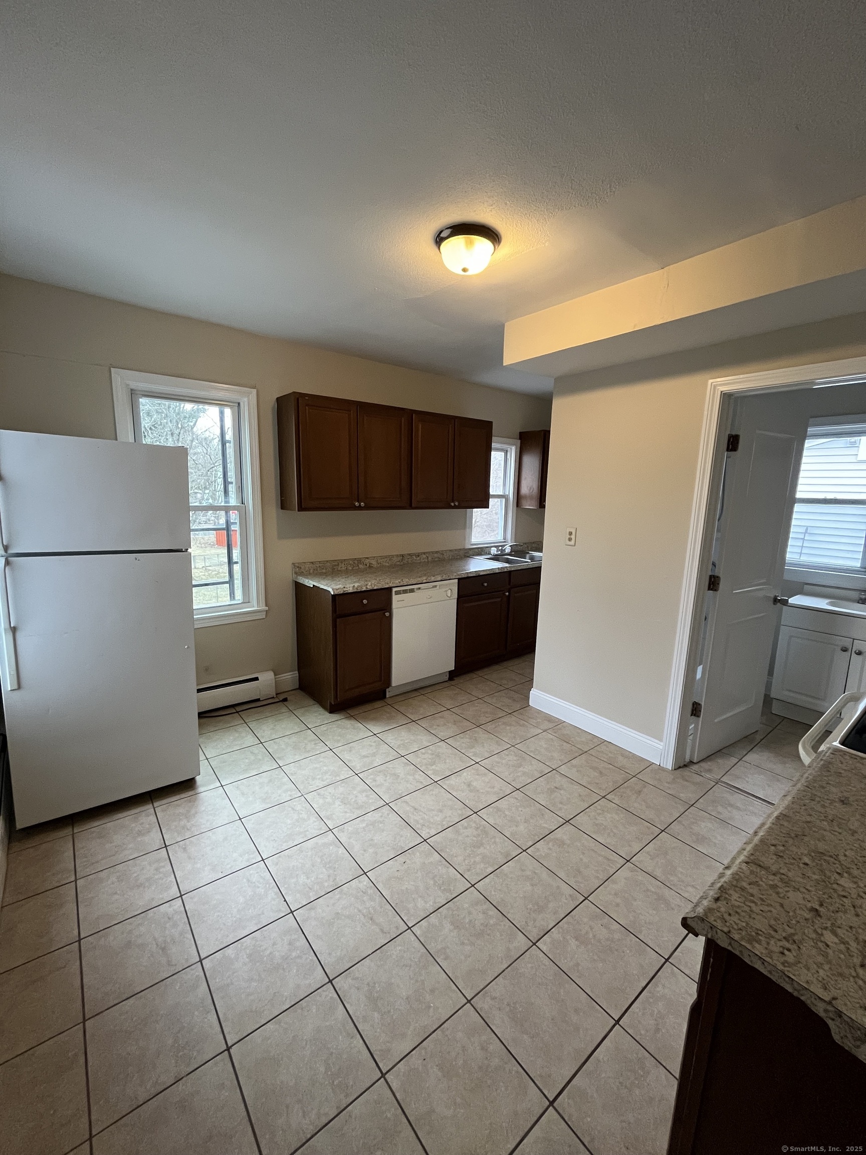 a kitchen with a sink and a refrigerator