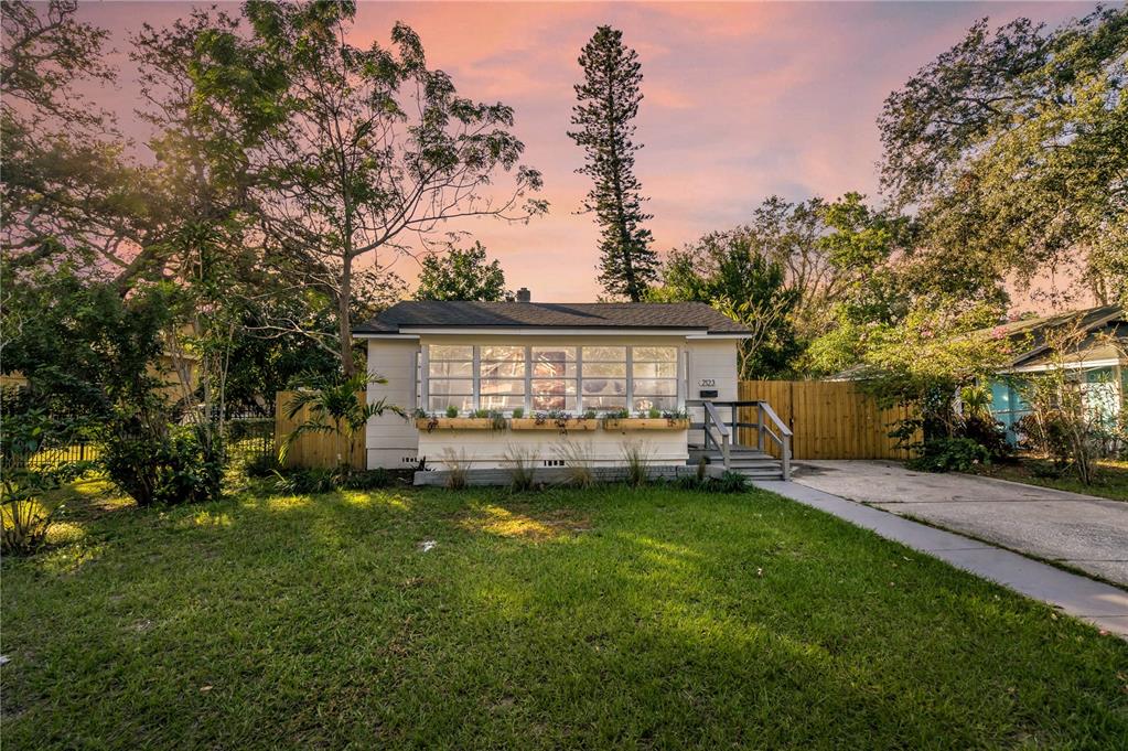 a view of a house with a yard porch and sitting area