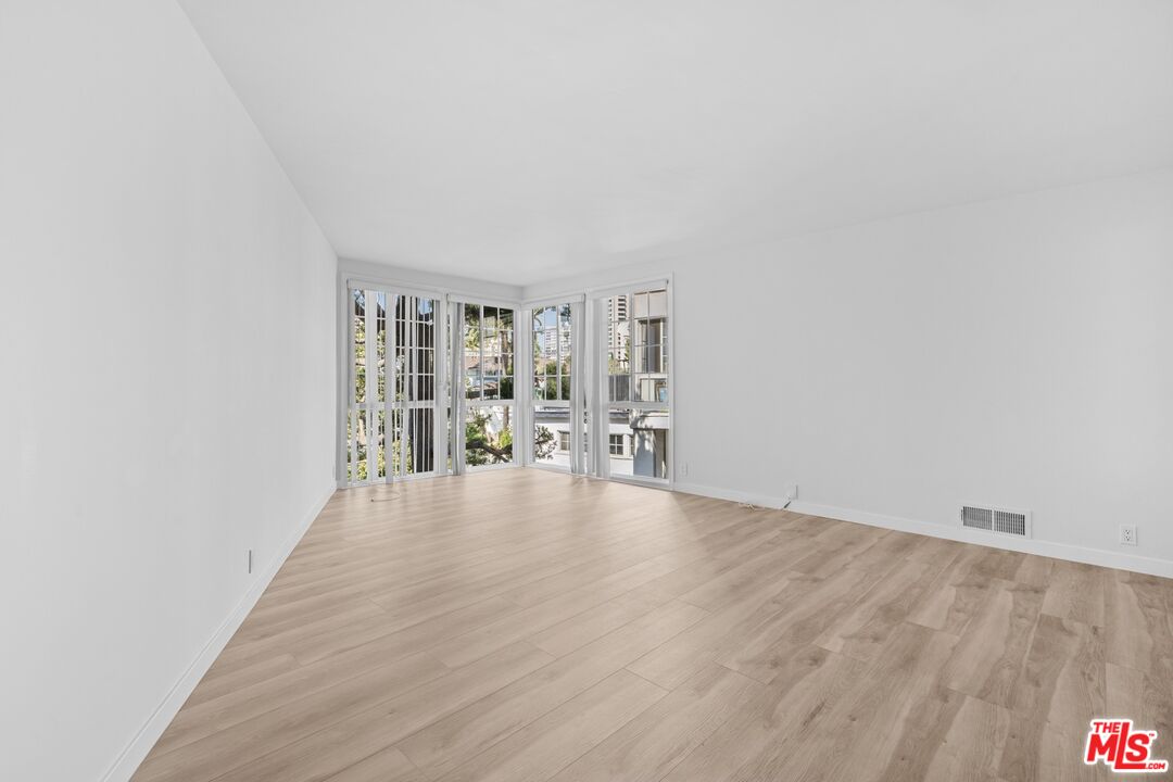 a view of an empty room with glass door