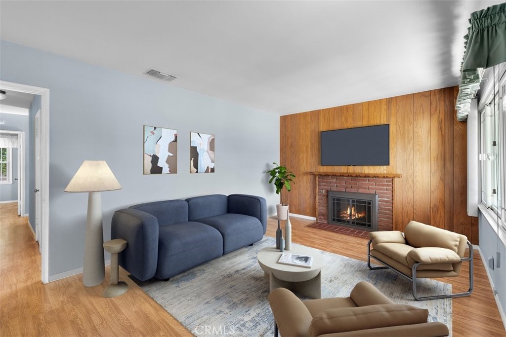 a living room with furniture a fireplace and a flat screen tv