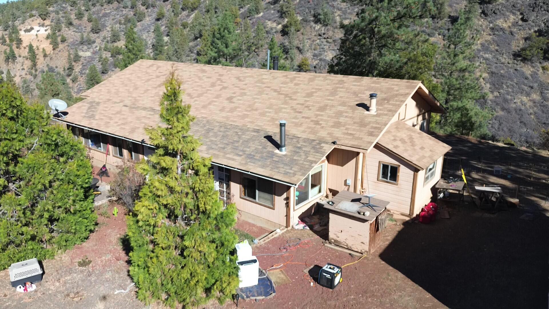 an aerial view of a house with a yard