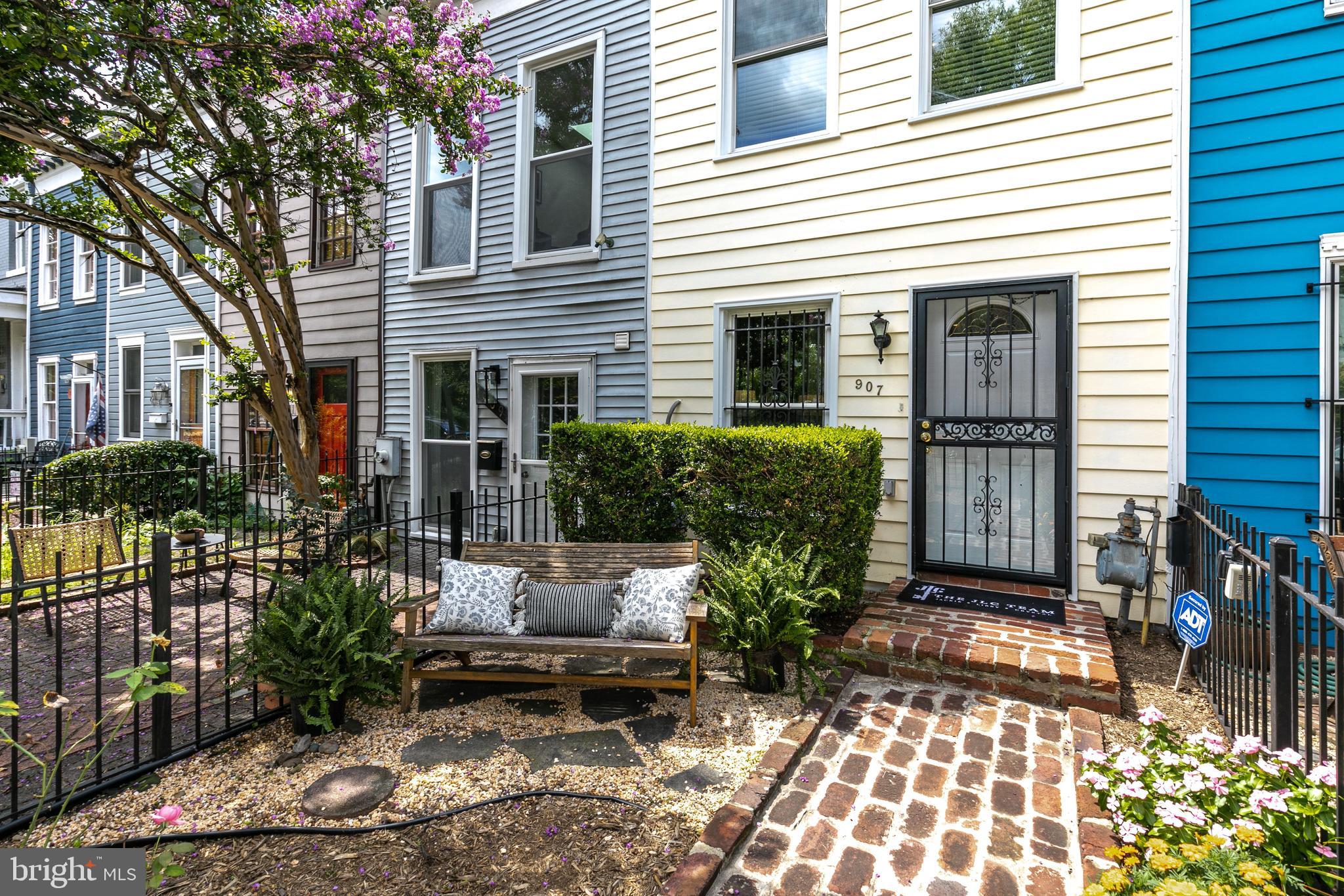 a view of a house with sitting area and potted plants