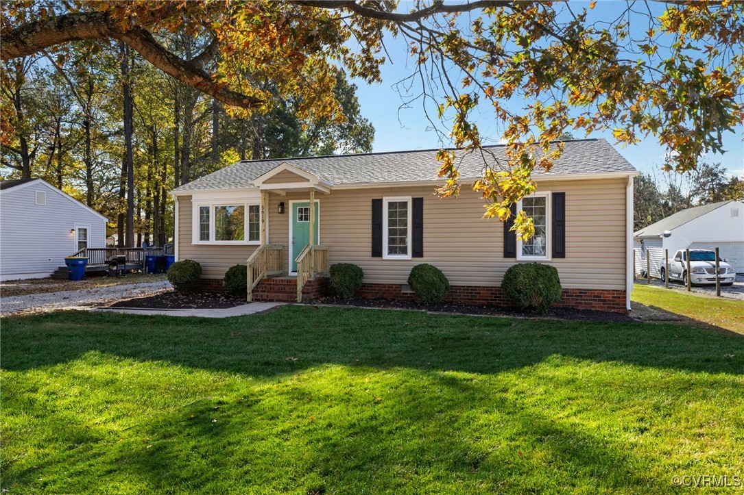 a front view of house with yard and green space