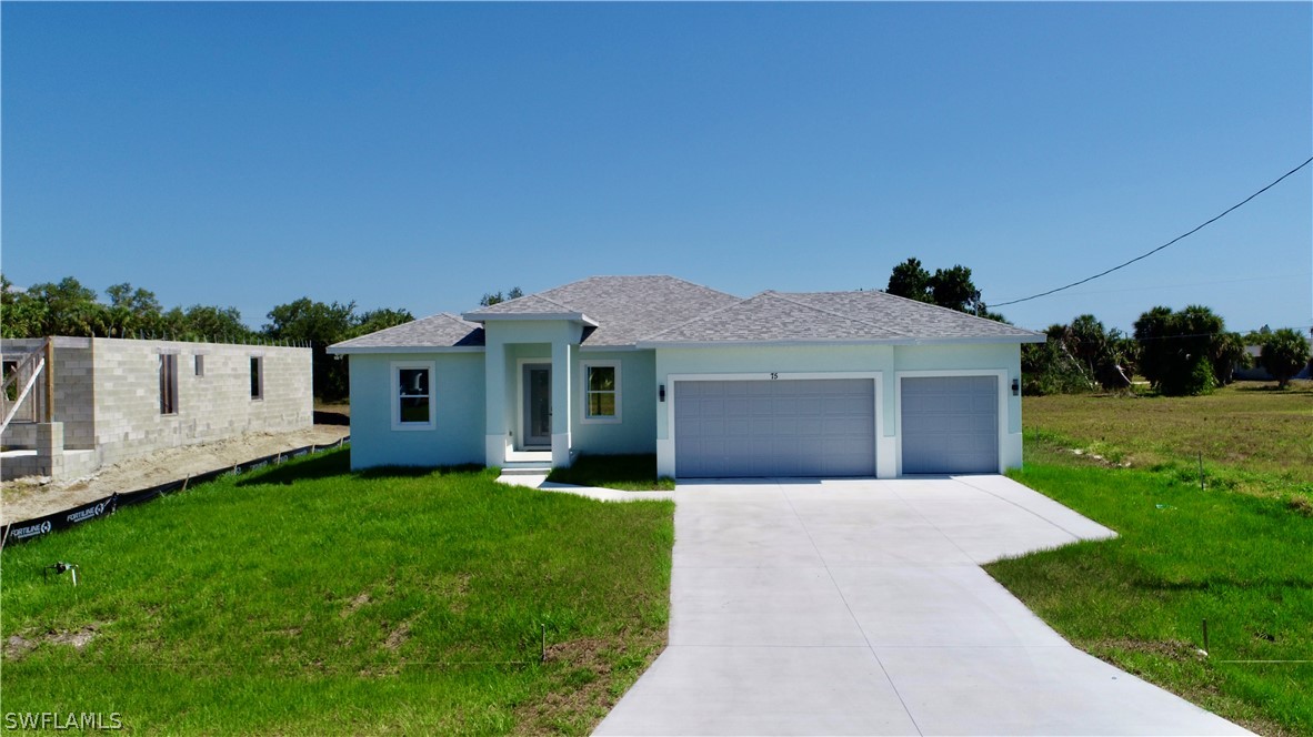 a front view of a house with a yard and garage