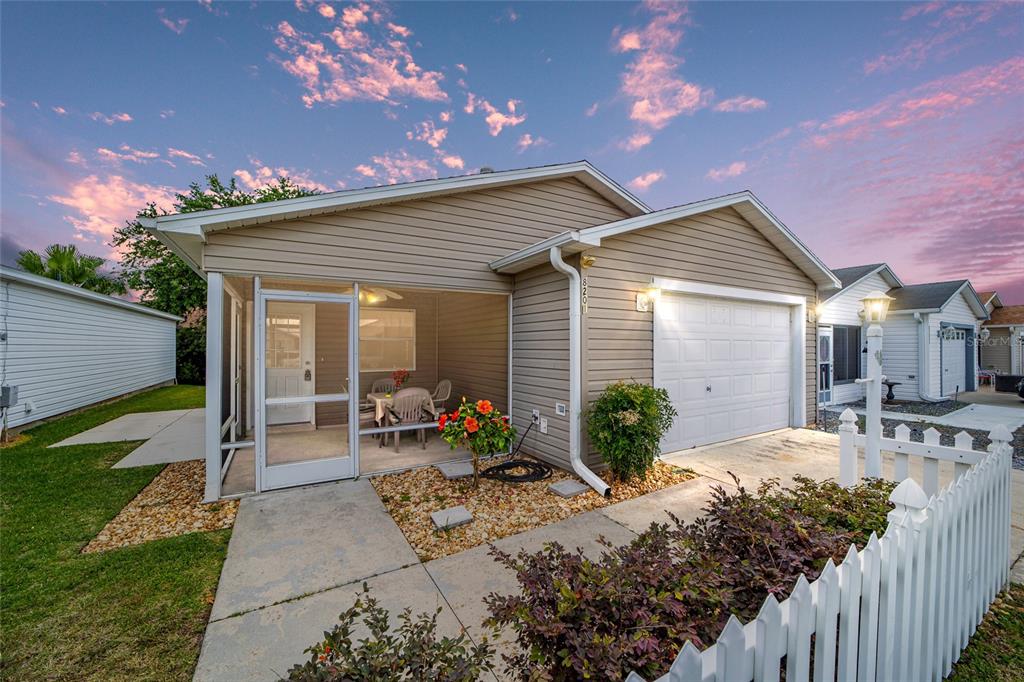 a view of a house with backyard sitting area and garden