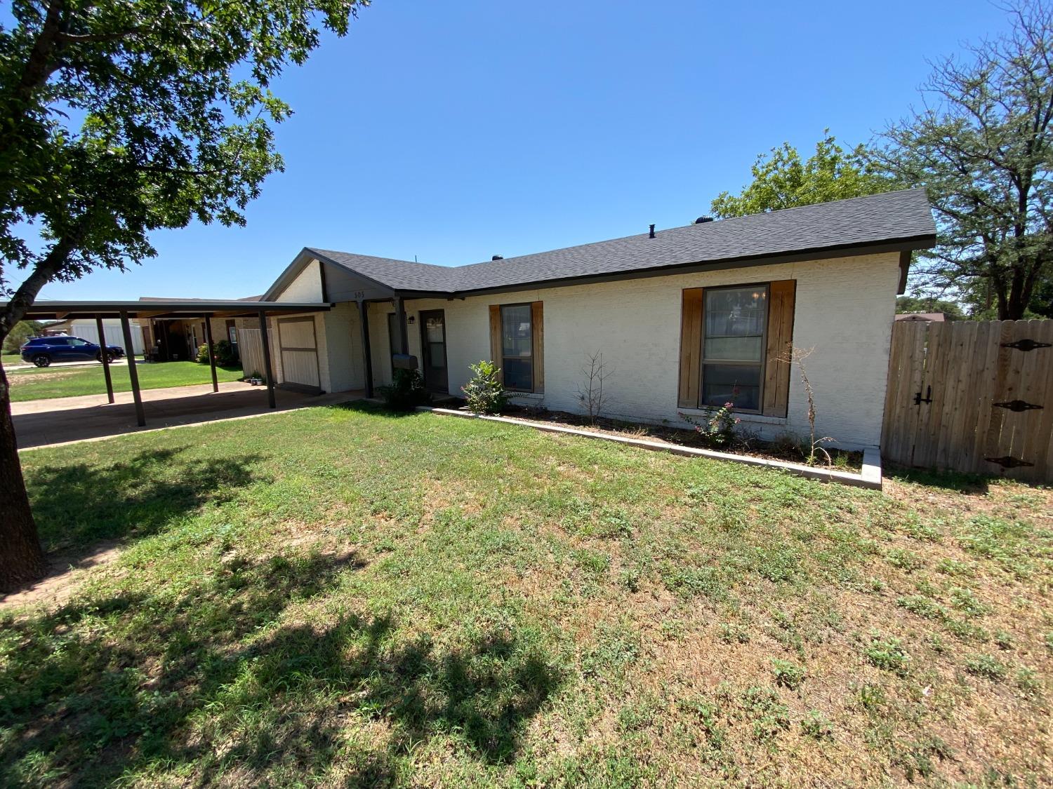 a front view of house with yard and trees