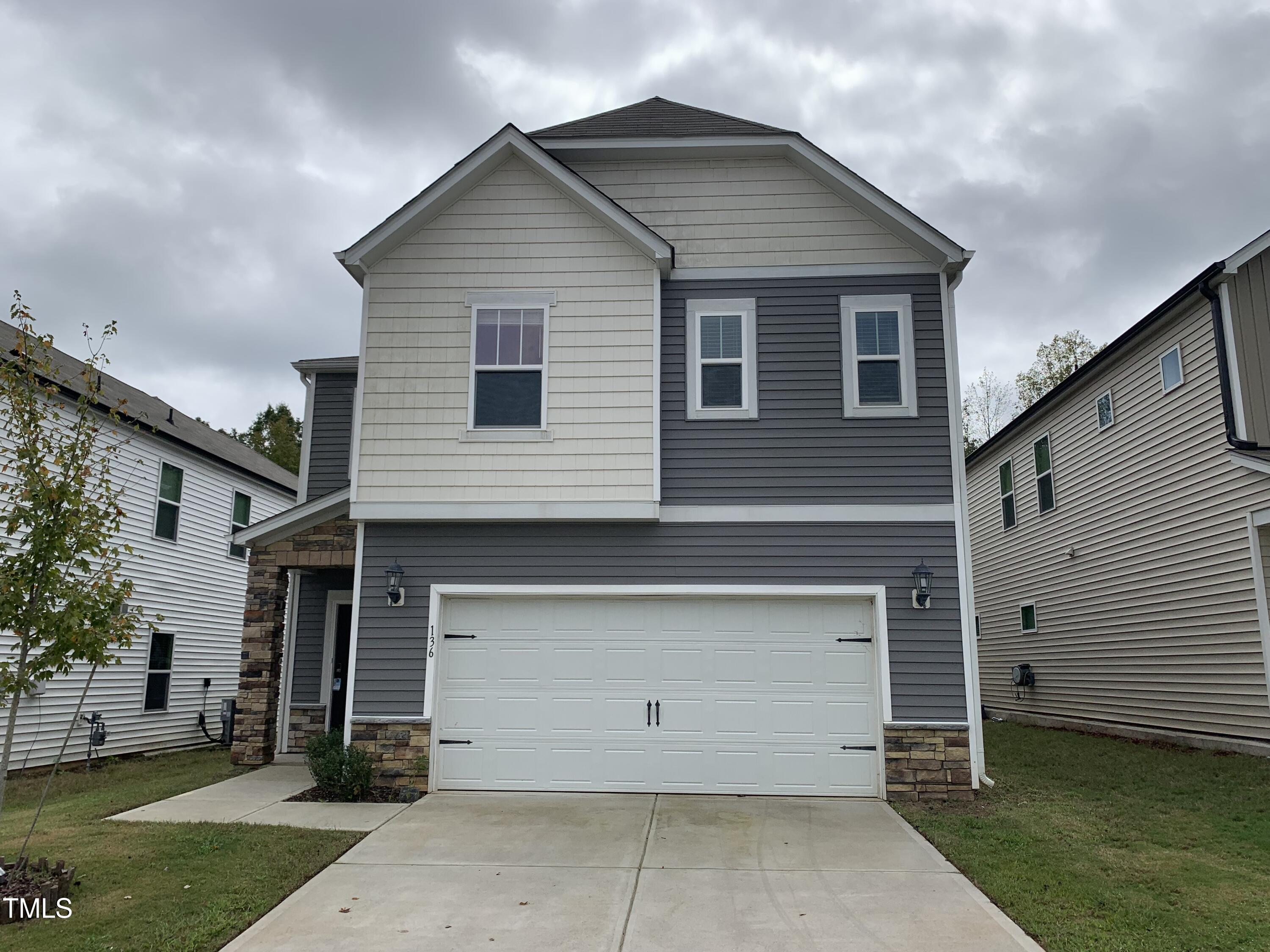 a front view of a house with a yard