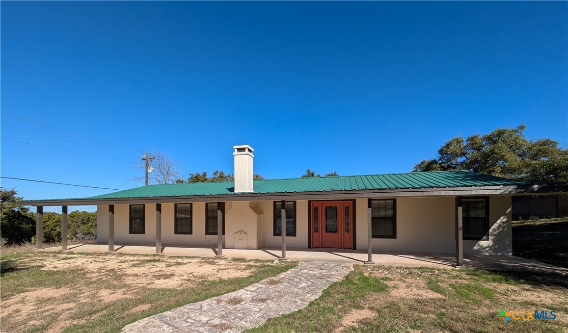 a front door view of a house with a yard