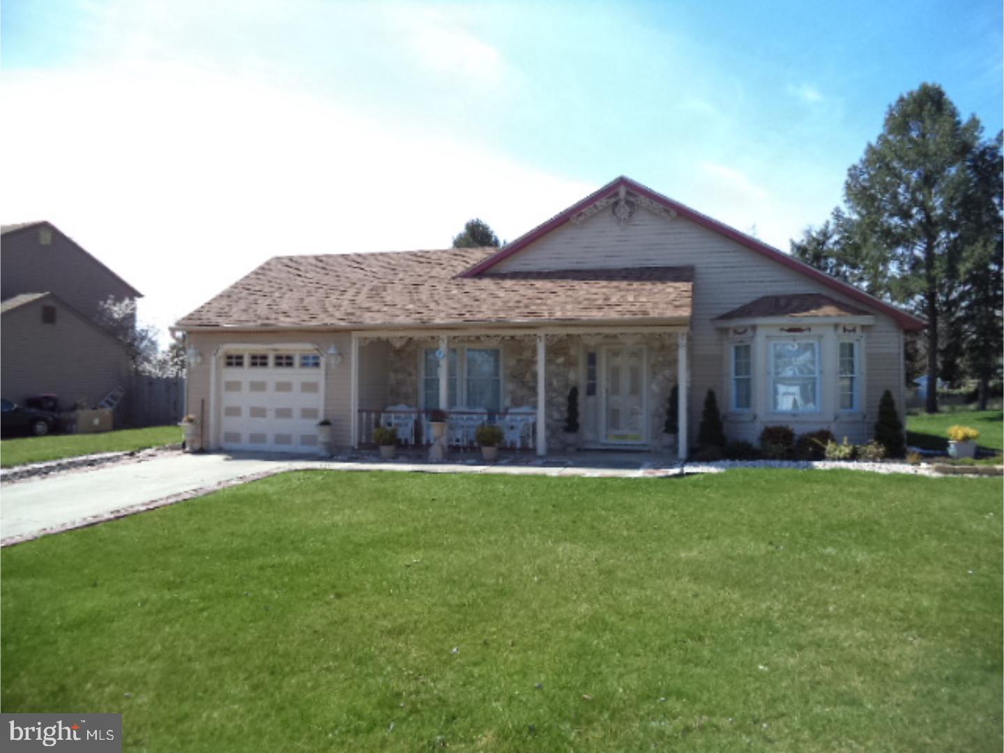 a front view of a house with a garden and porch