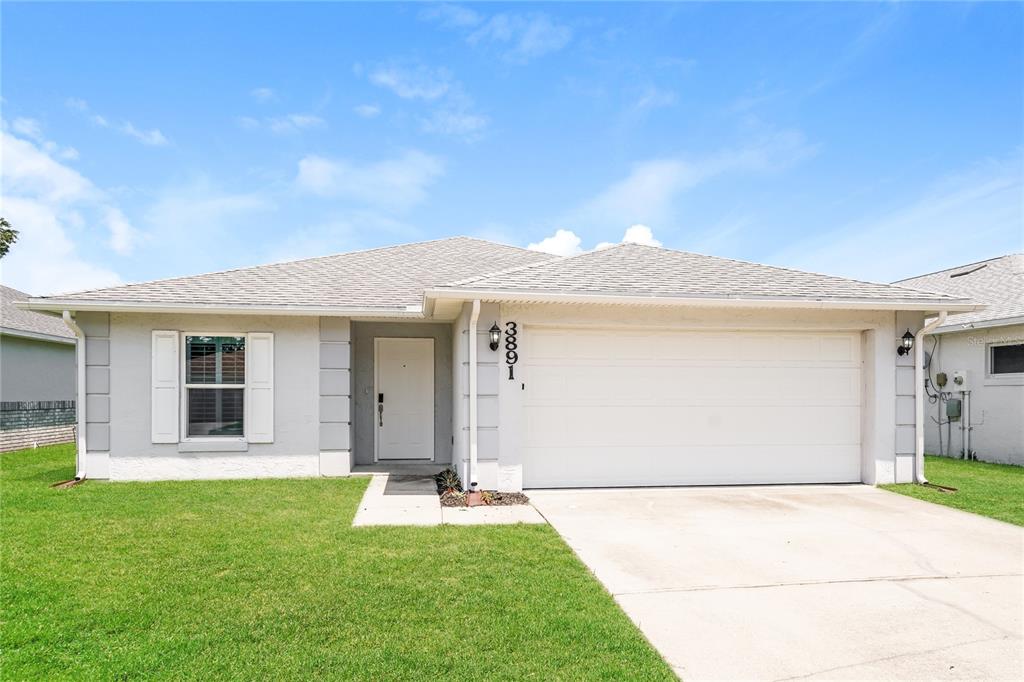 a front view of a house with a yard and garage