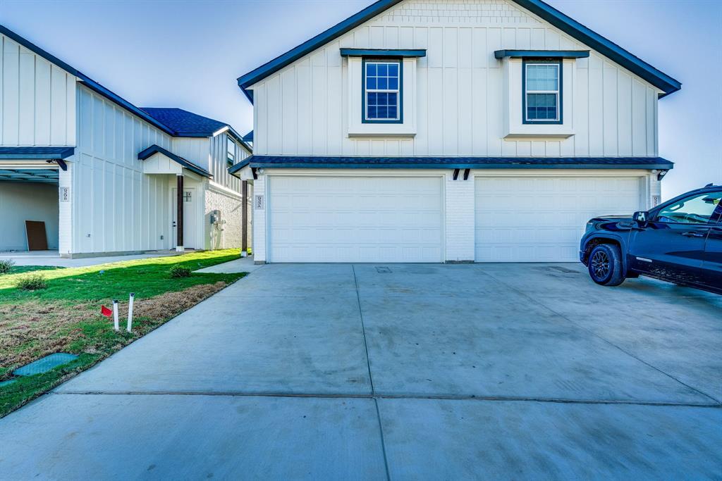 a view of a house with a yard and garage