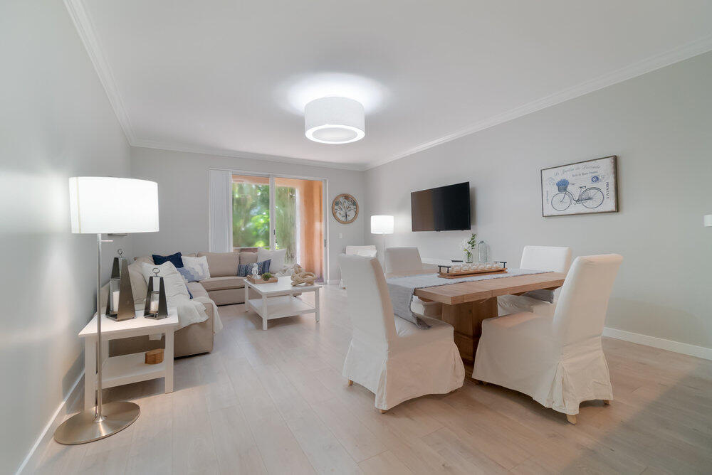 a view of a livingroom with furniture and a flat screen tv