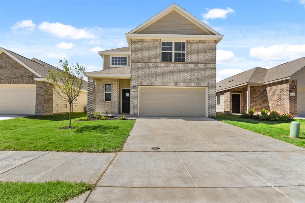 a front view of a house with a yard and garage